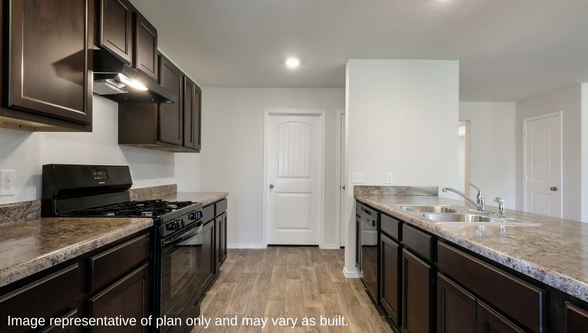 Spacious kitchen overlooking living area with hard surface flooring.