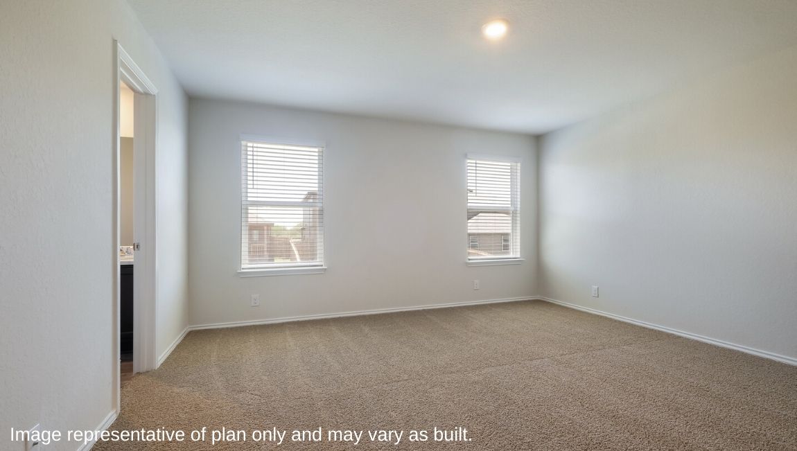 Spacious primary bedroom with quality carpet and ensuite bathroom.