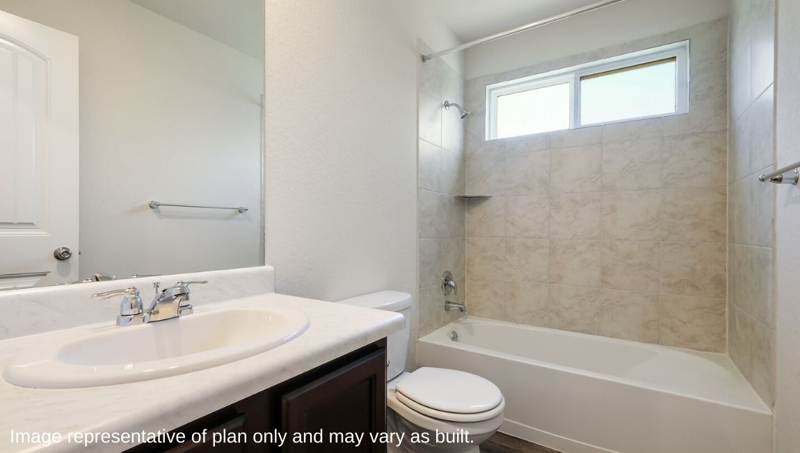 Secondary full bathroom with combined bathtub and shower, toilet and hard surface flooring.