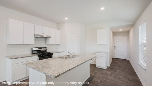 San Antonio Applewood New Construction Homes entry hallway kitchen with white cabinets black appliances corner pantry