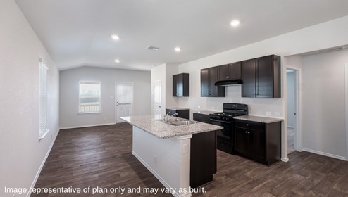 San Antonio Applewood New Construction Homes open concept kitchen and dining area with kitchen island dark cabinets and black appliances