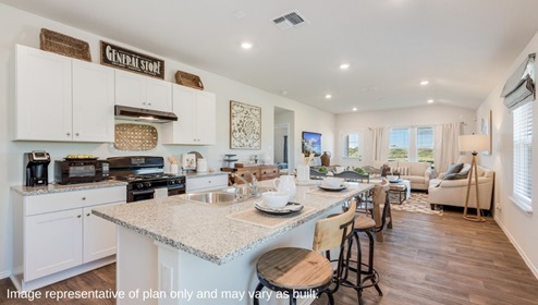 San Antonio Applewood New Construction Homes open concept kitchen dining and living with black appliances white cabinets kitchen island and barstools