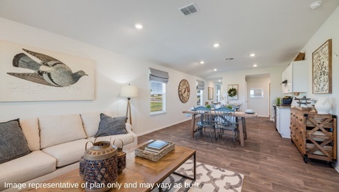 San Antonio Applewood New Construction Homes open concept living dining and kitchen area with white couch coffee table and geometric rug