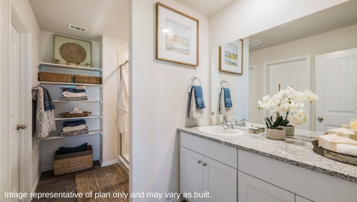 San Antonio Applewood New Construction Homes bedroom ensuite bathroom with white cabinets single vanity top walk in shower open air shelving and water closet