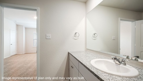 San Antonio Applewood New Construction Homes ensuite bathroom with single vanity sink white cabinets and view of private main bedroom