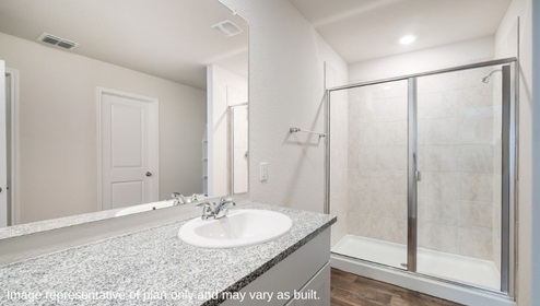 San Antonio Applewood New Construction Homes ensuite bathroom with plank flooring single vanity sink white cabinets and large walk in shower