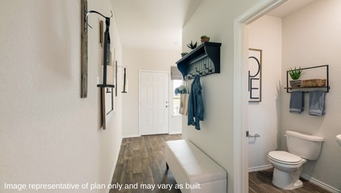 San Antonio Applewood New Construction Homes entry hallway with bench wall decorations and powder bathroom