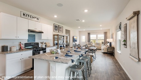 San Antonio Applewood New Construction Homes open concept kitchen dining and living room white cabinets black appliances large kitchen island wall menu floating shelves farm table