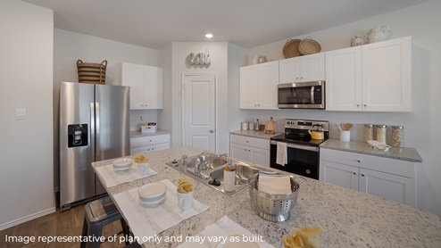 DR Horton Converse Avenida 4603 bontebok drive the jasmine floor plan 2 car 2 story 2463 square feet kitchen with corner pantry white cabinetry stainless steel appliances and spacious kitchen island with sink
