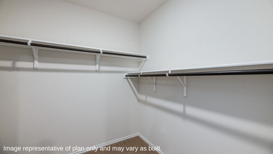 Spacious primary closet with shelving.