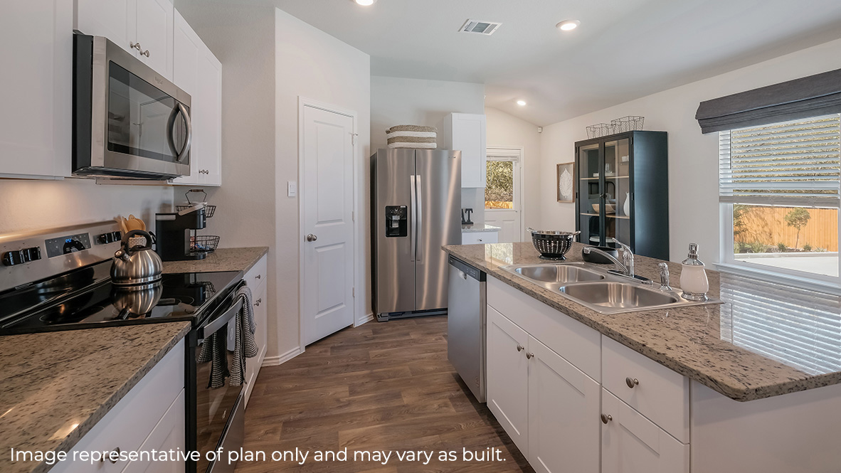 Open-concept kitchen with spacious corner pantry and plenty of cabinet space.