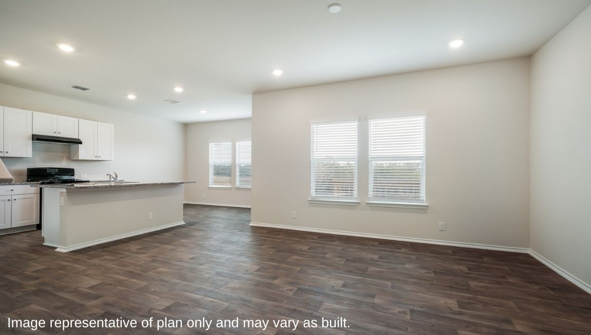 Open-concept living area with hard surface flooring and windows providing plenty of natural light.