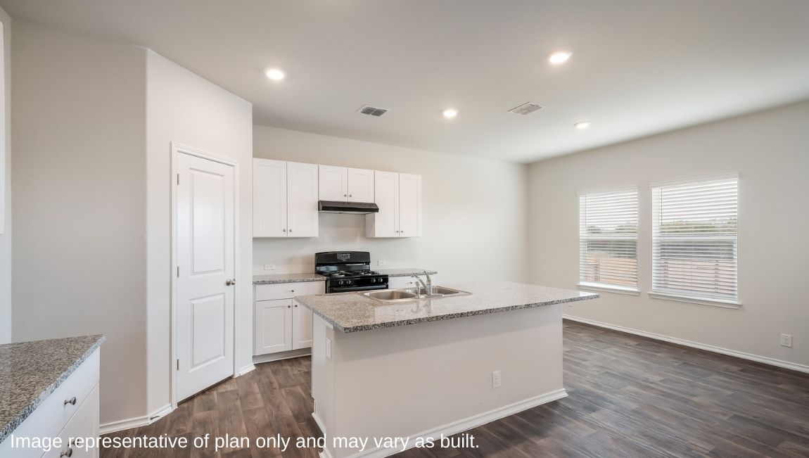 Open-concept kitchen with spacious corner pantry and plenty of cabinet space.