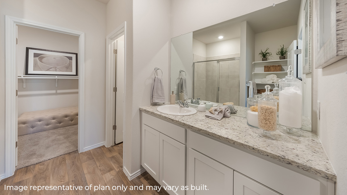 Spacious primary bathroom with plenty of counterspace, single vanity sink and hard surface flooring.