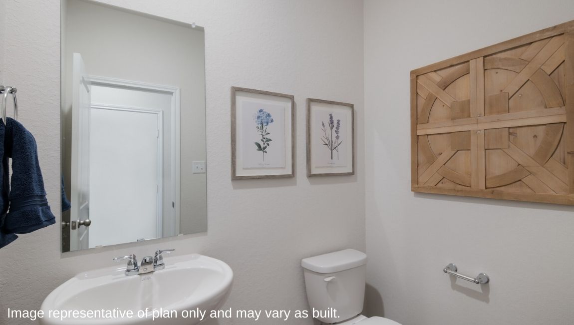 Powder bath with sink, toilet and hard surface flooring.