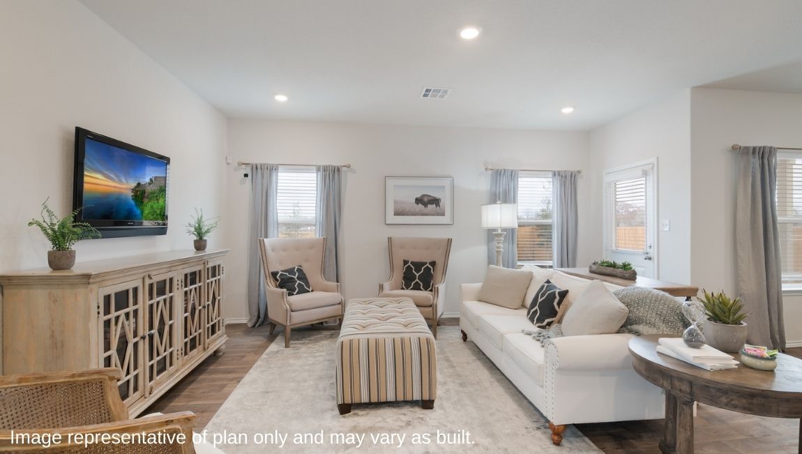 Open-concept living area with hard surface flooring and windows providing plenty of natural light.