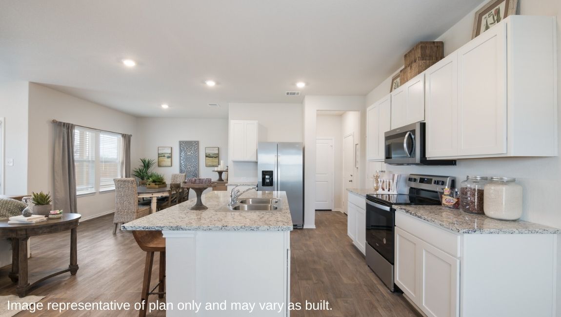 Spacious, open-concept kitchen with island, shaker style cabinets and granite countertops.
