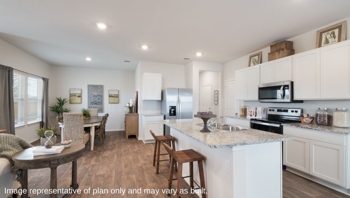 Spacious kitchen with granite countertops and hard surface flooring.