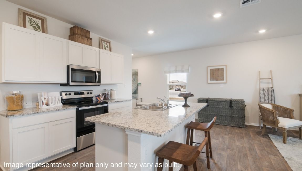 Kitchen overlooking dining and living areas with windows providing plenty of natural light.