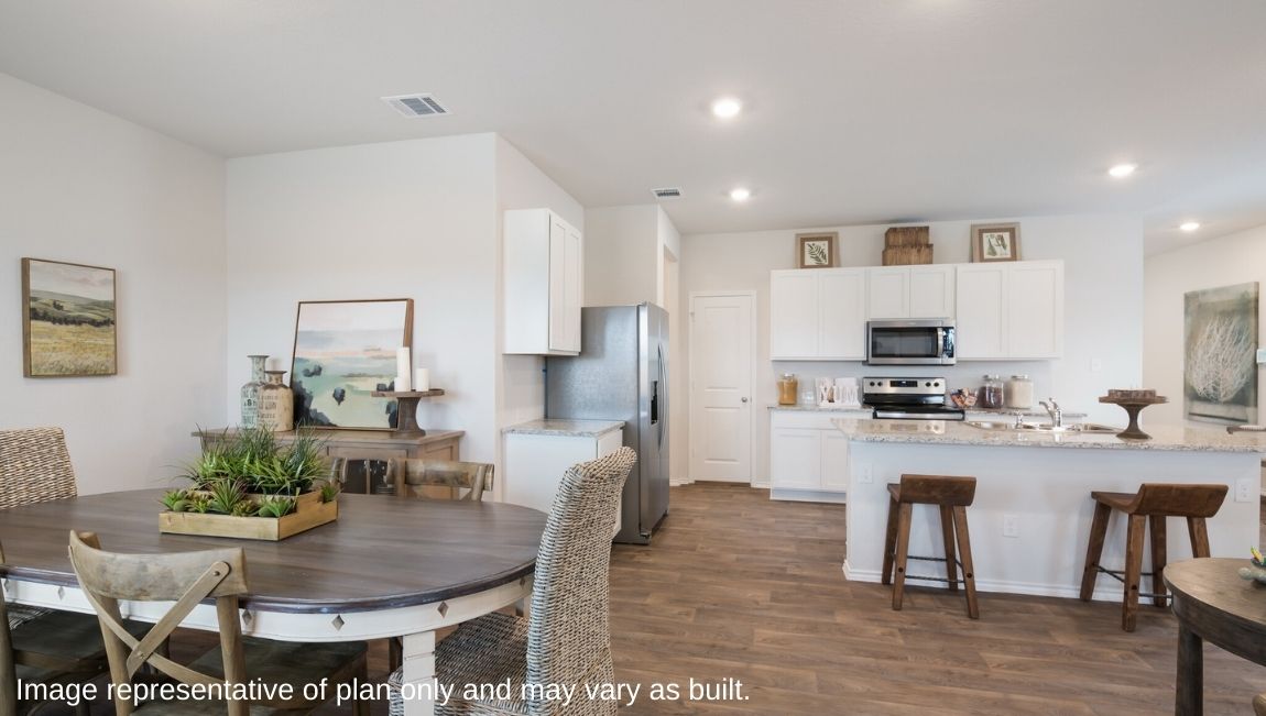 Spacious dining area facing window and overlooking living area.