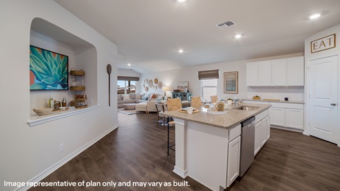 Open-concept kitchen with decorative nook facing the family room.