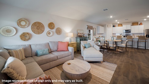 open-concept living room flowing to dining area and kitchen with hard surface flooring