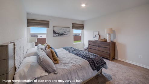 Primary bedroom with quality carpet and large window providing plenty of natural light