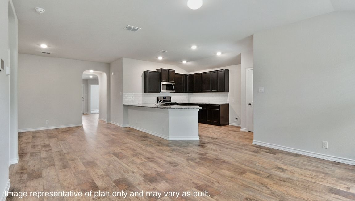 Spacious living area with hard surface flooring and windows providing plenty of light.