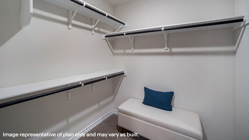 walk-in closet at primary ensuite bathroom with built in shelving