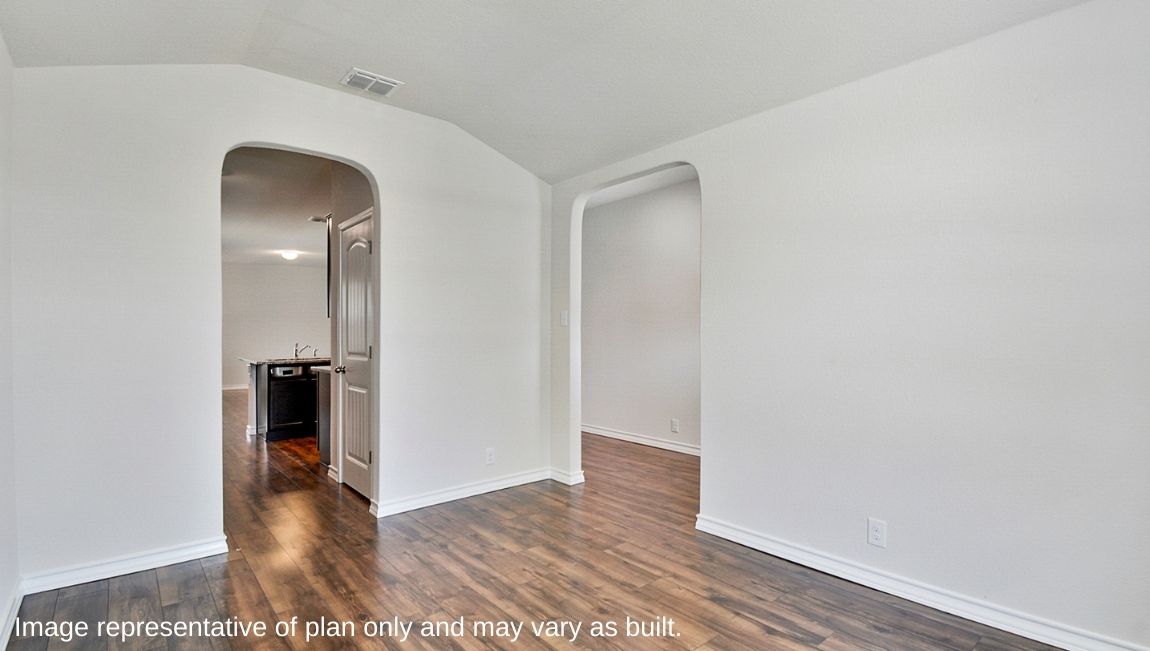 Entry way leading into spacious dining area with hard surface flooring.