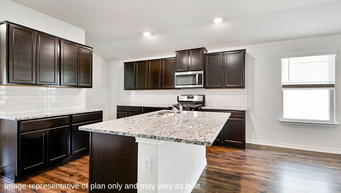 Spacious kitchen with plenty of cabinet storage, granite countertops and subway tile backsplash.