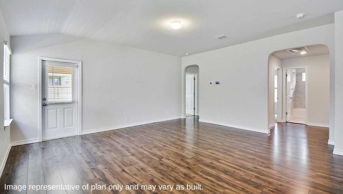 Living area with hard surface flooring and windows providing plenty of natural light.