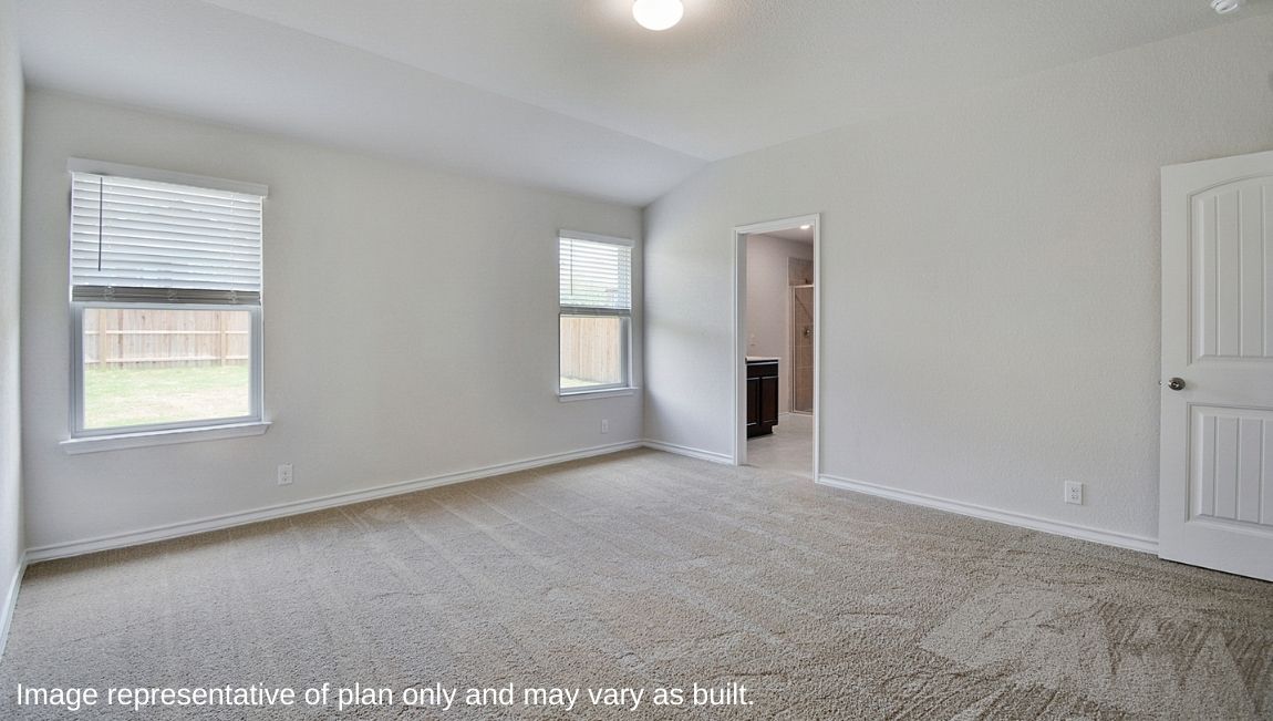 Primary bedroom with large windows, ensuite bathroom and walk-in closet.