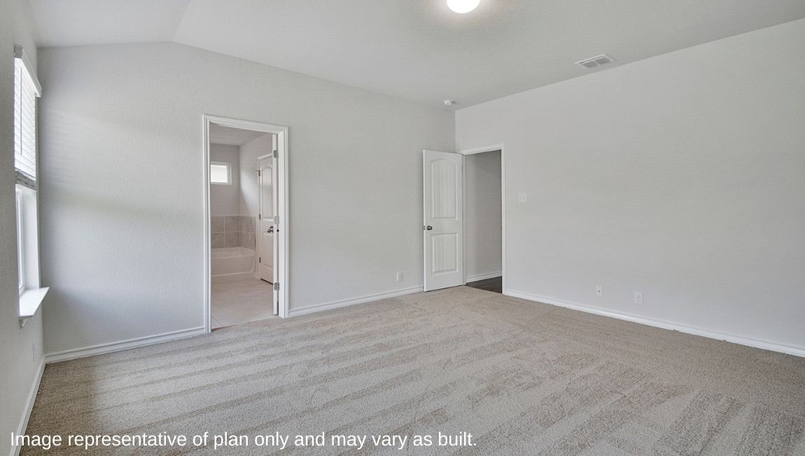 Spacious primary bedroom with large windows and quality carpet.