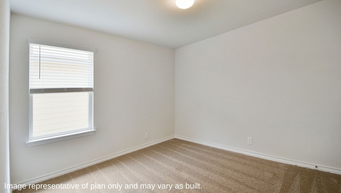 Secondary bedroom with quality carpet, closet and window.