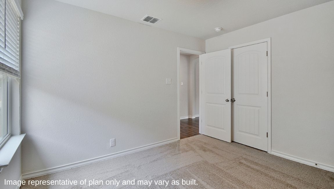 Third bedroom with window and closet with shelving.