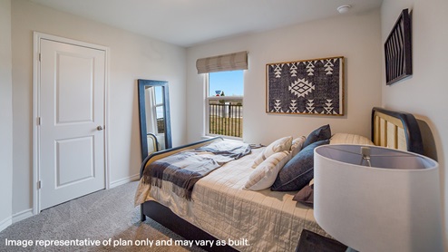 third bedroom with carpet flooring, large window and closet