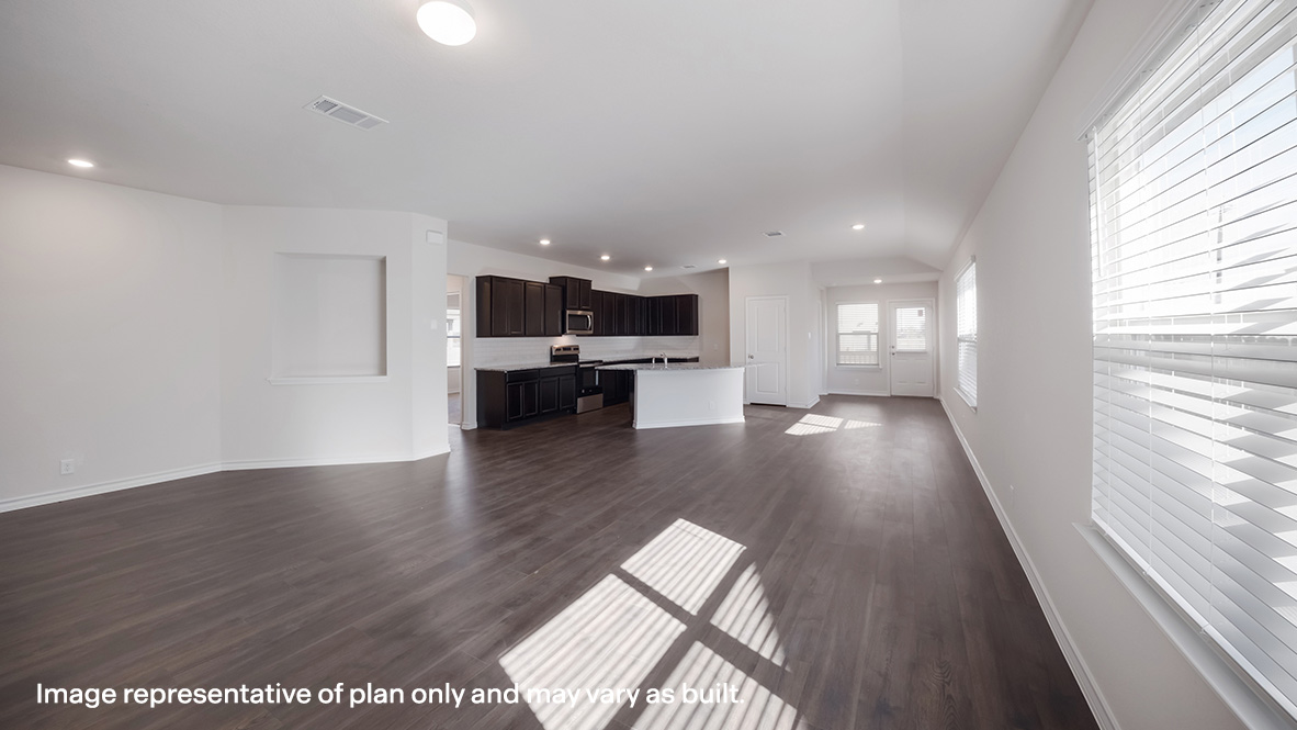 Spacious living area with hard surface flooring overlooking kitchen.