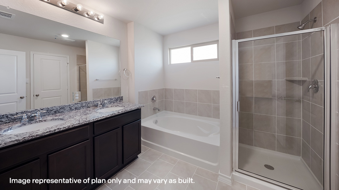 Spacious primary bathroom with hard surface flooring and walk-in closet.