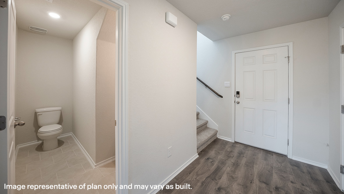 Foyer entry opening up to living, dining and kitchen space.