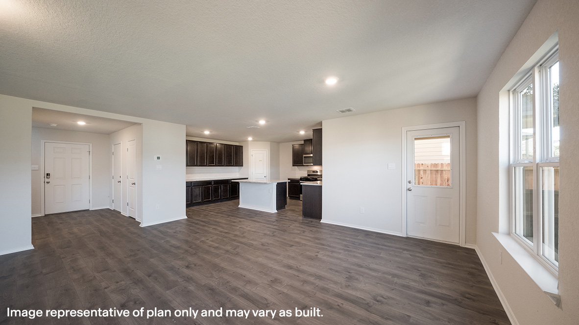 Spacious living and dining area with windows, patio door and hard surface flooring.