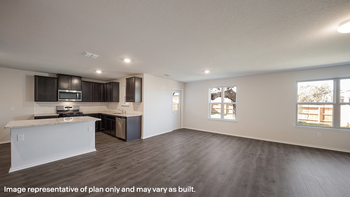 Open-concept kitchen and dining areas with hard surface flooring.