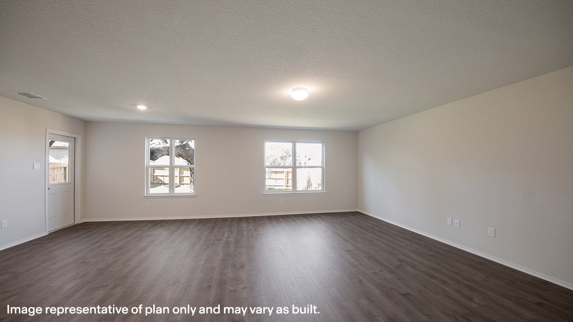 Open-concept living area with hard surface flooring and patio door.