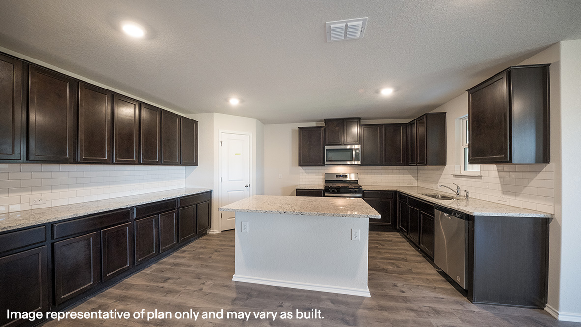 Large, spacious kitchen with tons of cabinet storage and countertop space.