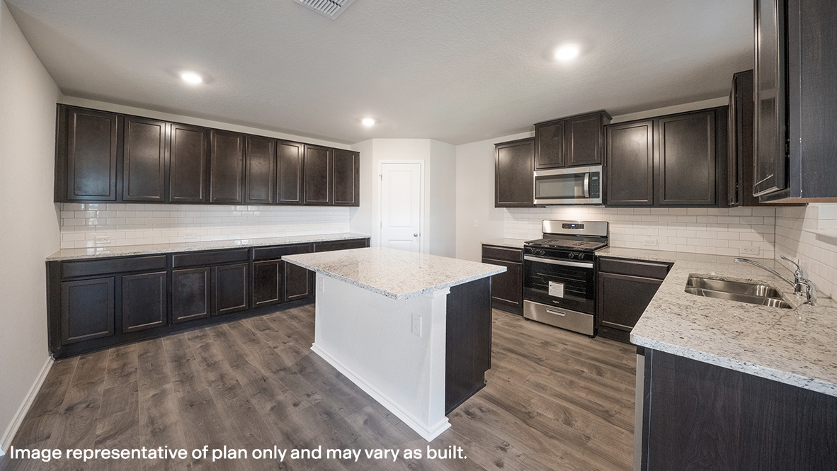Open-concept kitchen with granite countertops, island and stainless steel appliances.