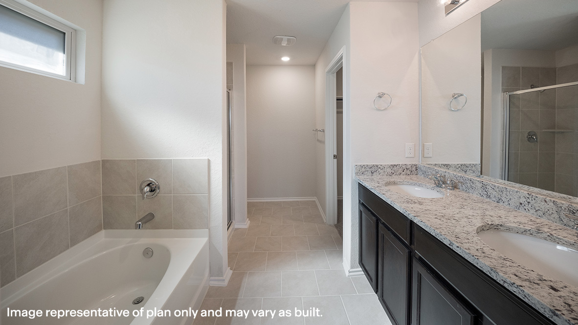Spacious primary bathroom with walk in closet and plenty of counterspace.