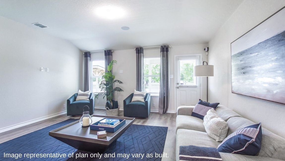 Open-concept living area with large windows providing plenty of natural light.