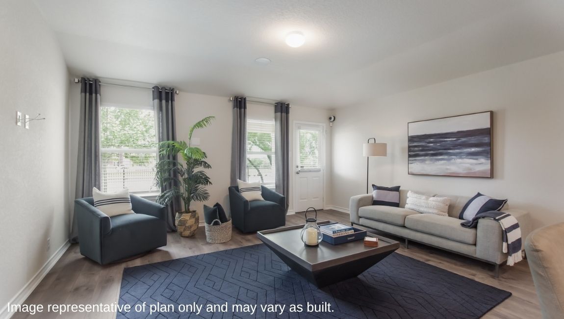 Spacious living area with hard surface flooring, facing kitchen.