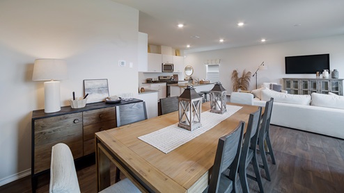 Spacious dining area facing window and overlooking living area.