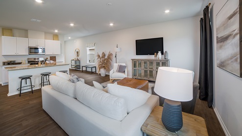 Open-concept living area with hard surface flooring and windows providing plenty of natural light.